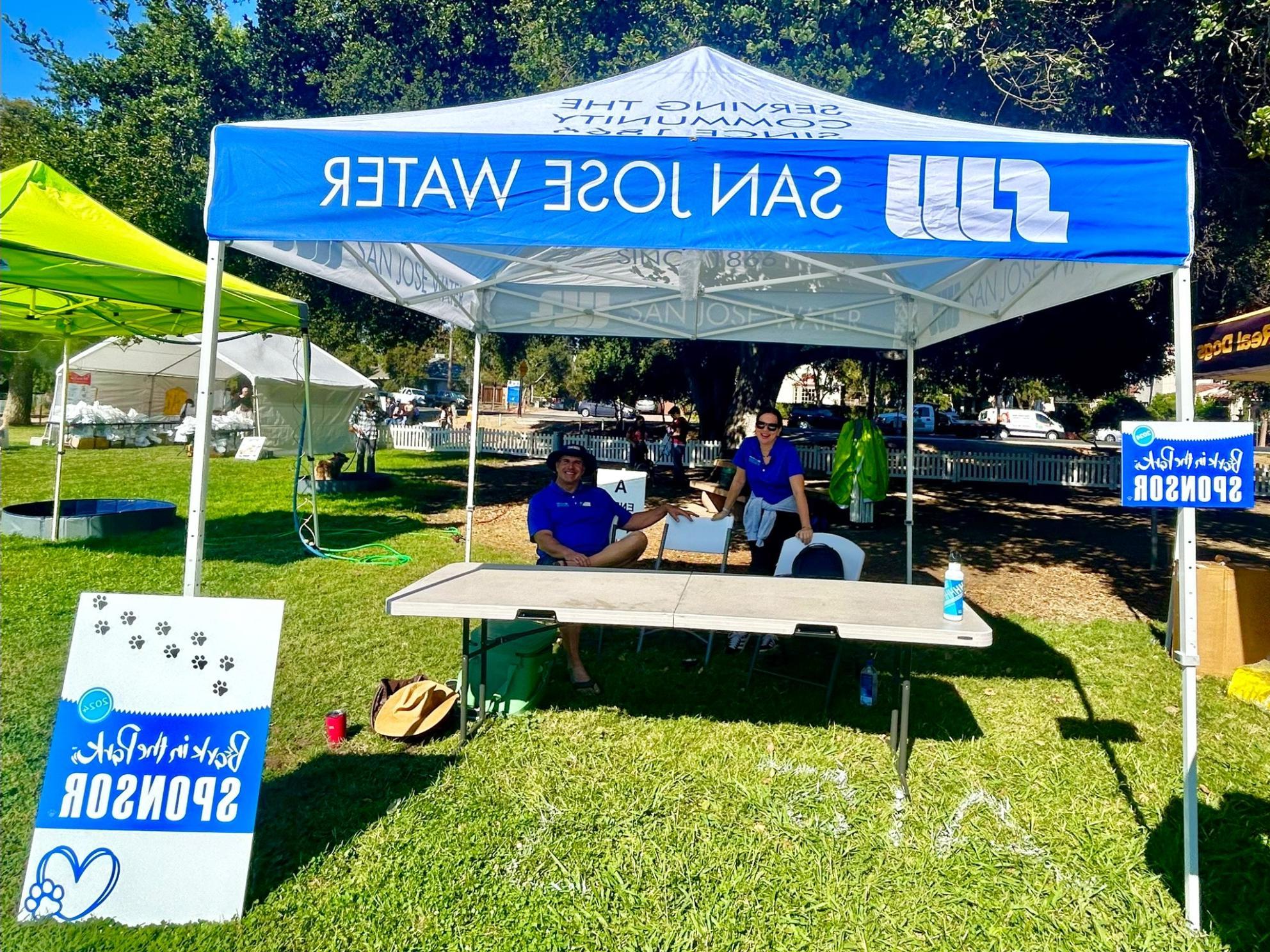 Two SJW staff members at Bark in the Park sponsor booth